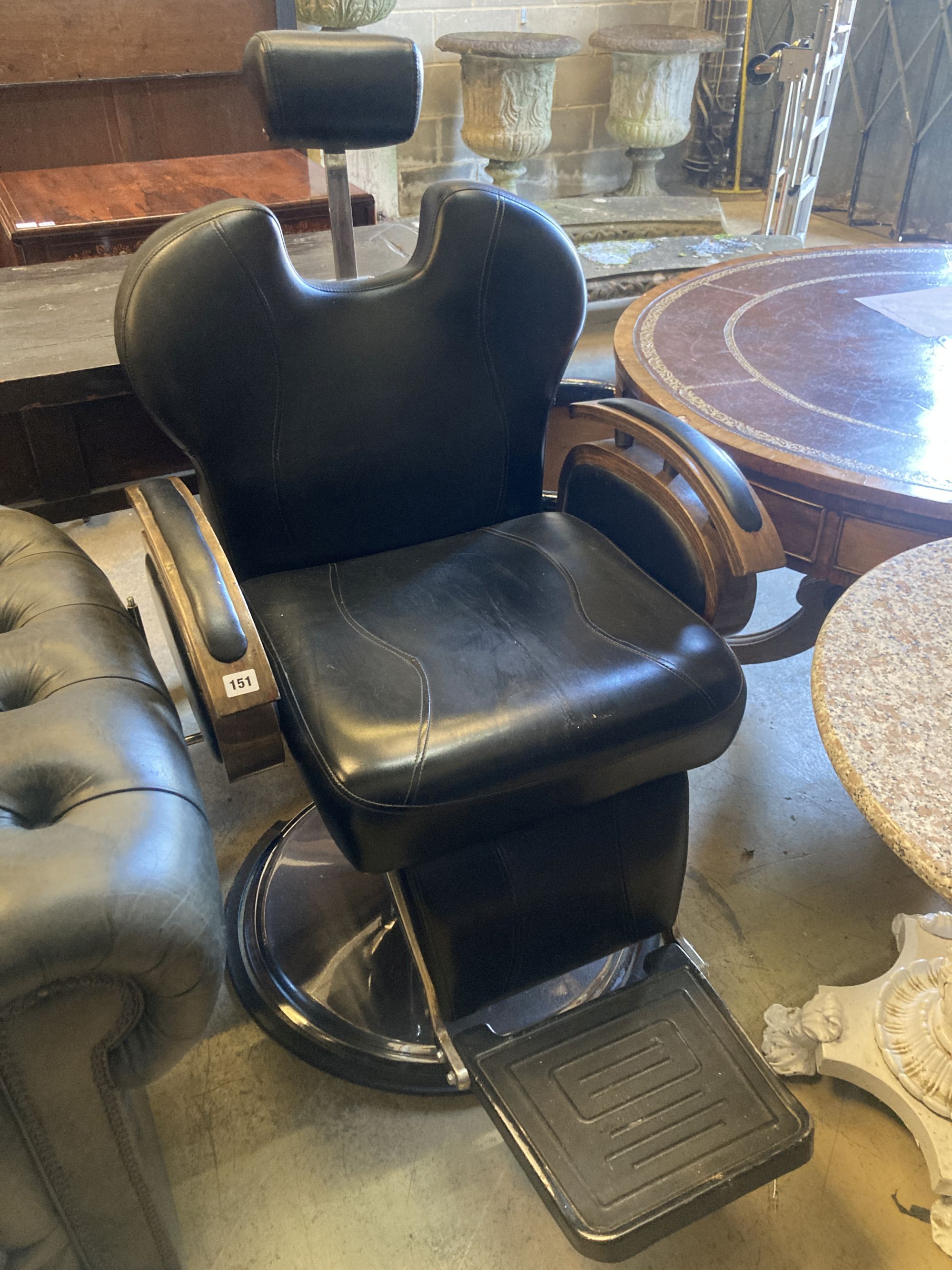 A black leatherette adjustable barbers chair, width 70cm, height 120cm